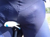 Piss into a cycling bib during street bicycle journey